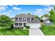 Charming two-story home featuring a well-manicured lawn and a classic white exterior with black shutters at 1234 Breaside Cir, Greenwood, IN 46143