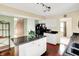 Well-lit kitchen with white cabinets, island, and modern appliances offers style and functionality at 1234 Breaside Cir, Greenwood, IN 46143