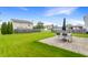 Large backyard with a patio area for outdoor dining and a lush lawn at 12444 Bearsdale Dr, Indianapolis, IN 46235