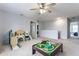 Spacious bonus room with neutral carpeting and a ceiling fan provides flexible living space at 12444 Bearsdale Dr, Indianapolis, IN 46235