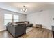 Spacious living room with a comfortable sectional sofa, wood flooring, and plenty of natural light at 12444 Bearsdale Dr, Indianapolis, IN 46235
