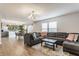 Open-concept living room flowing into a kitchen with green cabinets and modern appliances at 12444 Bearsdale Dr, Indianapolis, IN 46235