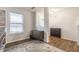 Well-lit office space showcasing wood-look flooring and stylish storage cabinets under a bright window at 12444 Bearsdale Dr, Indianapolis, IN 46235