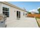 This backyard shows a large concrete patio, grill, flower beds and a lawn at 12496 Wolf Run Rd, Noblesville, IN 46060