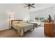 Bright bedroom features two beds, ceiling fan, neutral carpet, and a large window for natural light at 12496 Wolf Run Rd, Noblesville, IN 46060