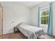 Bedroom features a single bed, neutral carpet, and a window with curtains for natural light at 12496 Wolf Run Rd, Noblesville, IN 46060