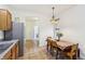 Charming dining area featuring a classic chandelier and a window with natural light, perfect for Gathering meals at 12496 Wolf Run Rd, Noblesville, IN 46060