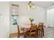 Bright dining area with natural light streaming through the window, complemented by a traditional chandelier at 12496 Wolf Run Rd, Noblesville, IN 46060