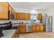 Bright kitchen with stainless steel appliances, ample wooden cabinetry, and functional layout at 12496 Wolf Run Rd, Noblesville, IN 46060