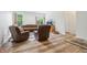 Cozy living room featuring hardwood floors, comfortable seating, and plenty of natural light at 12496 Wolf Run Rd, Noblesville, IN 46060