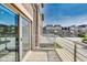 Private outdoor balcony with wood flooring, metal railing, and view of neighboring townhomes at 13050 Grand Vue Dr, Carmel, IN 46032