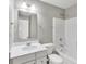 Bright bathroom features a white sink, vanity, mirror, toilet, and shower-tub combination at 13050 Grand Vue Dr, Carmel, IN 46032