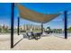 Outdoor community space offers shade, seating, and a scenic view of the water features at 13050 Grand Vue Dr, Carmel, IN 46032
