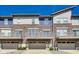 Modern townhomes with brick facade, balconies, and attached garages at 13050 Grand Vue Dr, Carmel, IN 46032