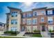 Modern townhouse featuring a combination of brick and stone facade, complemented by well-manicured landscaping at 13050 Grand Vue Dr, Carmel, IN 46032