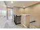 Upstairs hallway with neutral paint and carpet, with view of stairway at 13050 Grand Vue Dr, Carmel, IN 46032