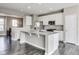 Modern kitchen featuring stainless steel appliances, a granite island, and white cabinets at 13050 Grand Vue Dr, Carmel, IN 46032