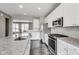 Modern kitchen with stainless steel appliances, granite countertops, and white cabinetry at 13050 Grand Vue Dr, Carmel, IN 46032