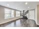 Living room features hardwood flooring, a staircase, and natural light from the windows at 13050 Grand Vue Dr, Carmel, IN 46032