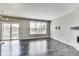 Open living room with window, sliding glass door to balcony, and modern recessed lighting at 13050 Grand Vue Dr, Carmel, IN 46032