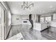 Spacious living room boasting dark hardwood floors, modern fireplace and contemporary chandelier at 13050 Grand Vue Dr, Carmel, IN 46032