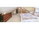 Sloped ceiling bedroom with quilt bedding and multiple dressers for ample storage space at 1352 Clinton St, Noblesville, IN 46060
