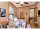Bedroom with hardwood floors, wood trim, quilt bedding, and a door leading to another room at 1352 Clinton St, Noblesville, IN 46060