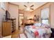 Cozy bedroom featuring a colorful patchwork quilt, wood trim, and connected bathroom at 1352 Clinton St, Noblesville, IN 46060