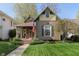 Charming home featuring a covered porch, well-manicured lawn, and an American flag display at 1352 Clinton St, Noblesville, IN 46060