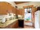 Well-lit kitchen with wood cabinets, granite countertops, and modern appliances at 1352 Clinton St, Noblesville, IN 46060