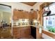 Cozy kitchen area with wood cabinets, granite countertops, and modern sink at 1352 Clinton St, Noblesville, IN 46060