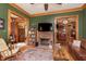 Cozy living room featuring a brick fireplace, hardwood floors, and charming vintage decor and woodwork at 1352 Clinton St, Noblesville, IN 46060