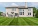 Home featuring a large backyard, deck, and lush green lawn at 13693 Cunningham Dr, Carmel, IN 46074
