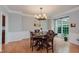 Dining room with hardwood floors, a large window, and a classic chandelier providing ample light for entertaining at 13693 Cunningham Dr, Carmel, IN 46074