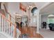 Bright foyer featuring hardwood floors, a staircase, and a large window offering plenty of natural light at 13693 Cunningham Dr, Carmel, IN 46074
