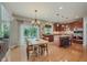 Open-concept kitchen and dining area with hardwood floors and natural light at 13693 Cunningham Dr, Carmel, IN 46074
