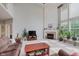 Bright living room featuring a fireplace, large windows, and neutral décor at 13693 Cunningham Dr, Carmel, IN 46074