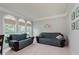 Cozy living room with large windows and comfortable seating, creating a welcoming and bright space at 13693 Cunningham Dr, Carmel, IN 46074