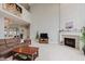 Bright and airy living room with a fireplace, high ceilings, and cozy seating, creating a welcoming atmosphere at 13693 Cunningham Dr, Carmel, IN 46074