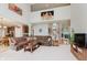 Open-concept living room with a large sectional sofa, seamlessly connecting to the kitchen and dining area at 13693 Cunningham Dr, Carmel, IN 46074