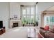 Spacious living room featuring a fireplace, large windows, and a comfortable seating area, perfect for relaxation at 13693 Cunningham Dr, Carmel, IN 46074