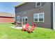 Home's backyard features chairs and a table on the green lawn at 1529 Fairmount Dr, Greenfield, IN 46140
