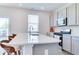 Bright kitchen features an island with a stone countertop and stylish seating at 1529 Fairmount Dr, Greenfield, IN 46140