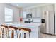 Modern kitchen island with bar stool seating, stainless appliances, and neutral cabinets at 1529 Fairmount Dr, Greenfield, IN 46140