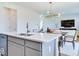 Open concept kitchen with quartz countertops, flowing into a dining room and living room area at 1529 Fairmount Dr, Greenfield, IN 46140