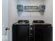Modern laundry room with black washer and dryer and shelving at 1529 Fairmount Dr, Greenfield, IN 46140