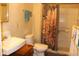Bathroom with a toilet, sink, shower, and a floral shower curtain at , Indianapolis, IN 46220