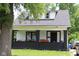 Charming home with a cozy front porch, black brick accents, and a welcoming entrance at , Indianapolis, IN 46220