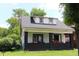 Cute home featuring a covered front porch with brick supports and dormer windows at , Indianapolis, IN 46220
