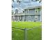 View of the back of the home with a large lawn, open patio, and fenced perimeter at 1831 Beckenbauer Ln, Indianapolis, IN 46214